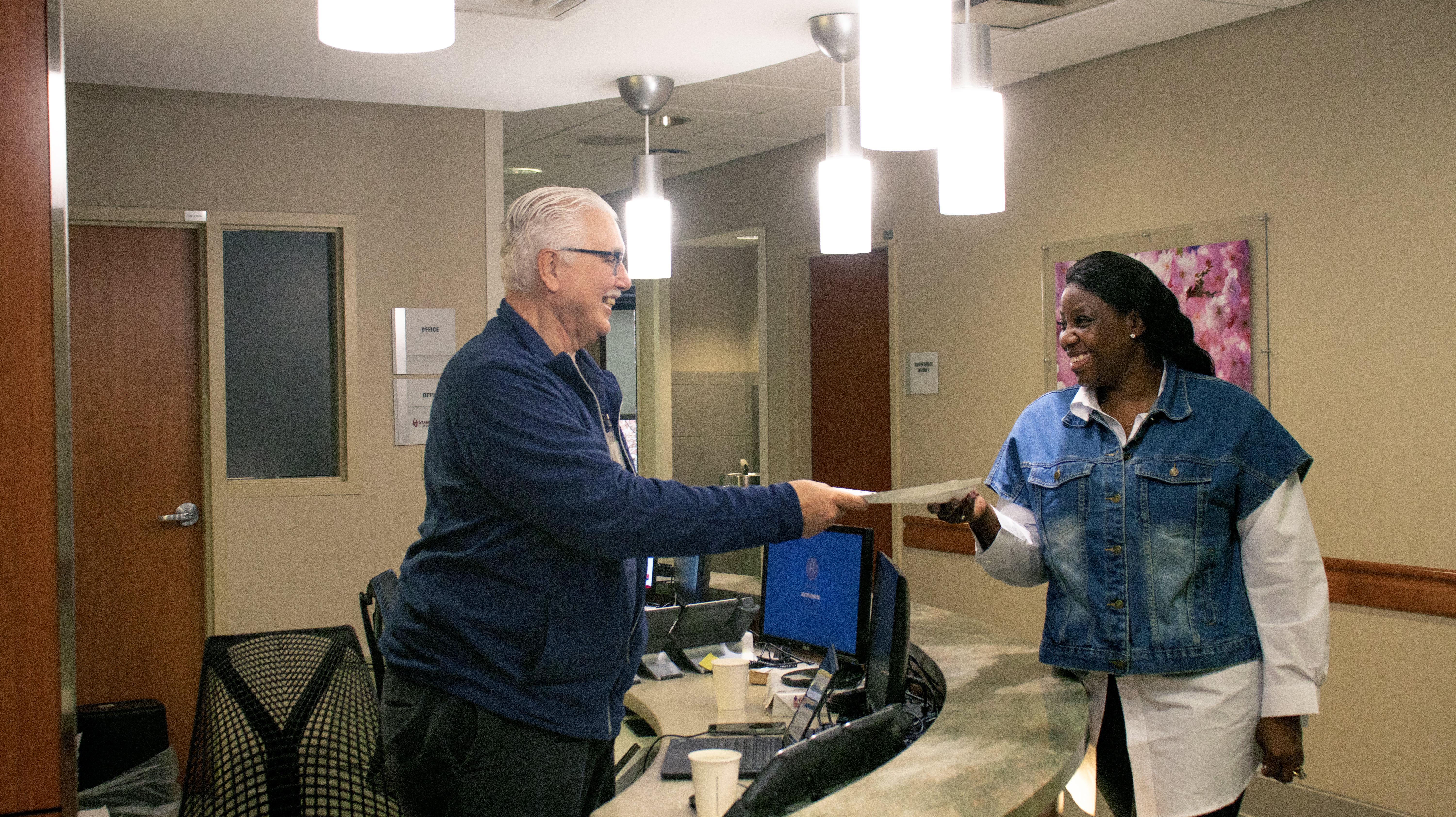 a volunteer greeting a patient