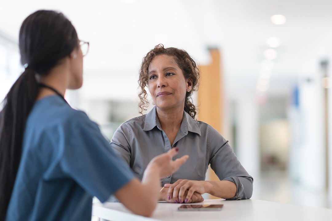 a nurse talking to a patient