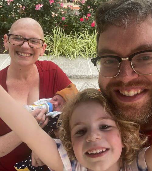 mom, dad, and daughter smiling