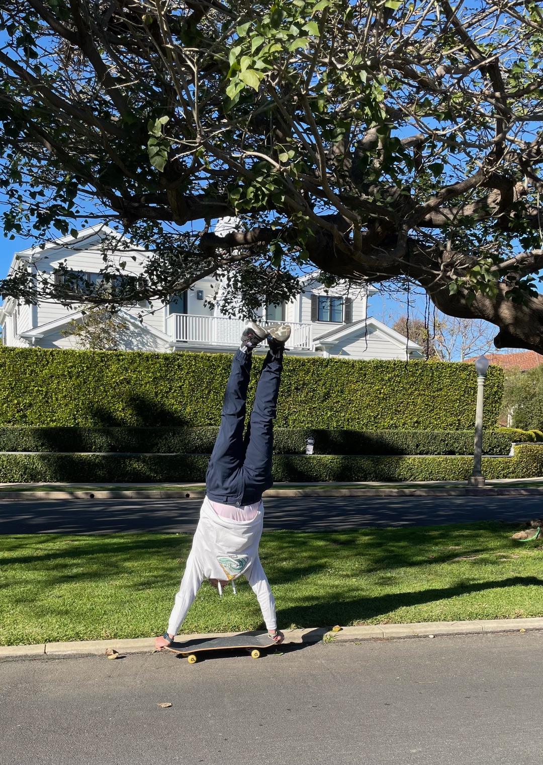 a man doing a handstand on a skateboard