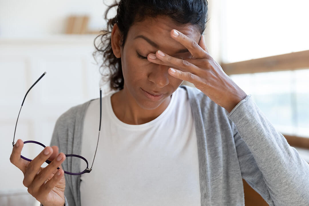 woman holding her forehead